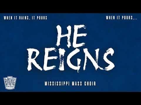 Blue poster announcing 'HE REIGNS' by the Mississippi Mass Choir, with the slogan 'When it rains, it pours' at the top and a small choir logo in the bottom-left.